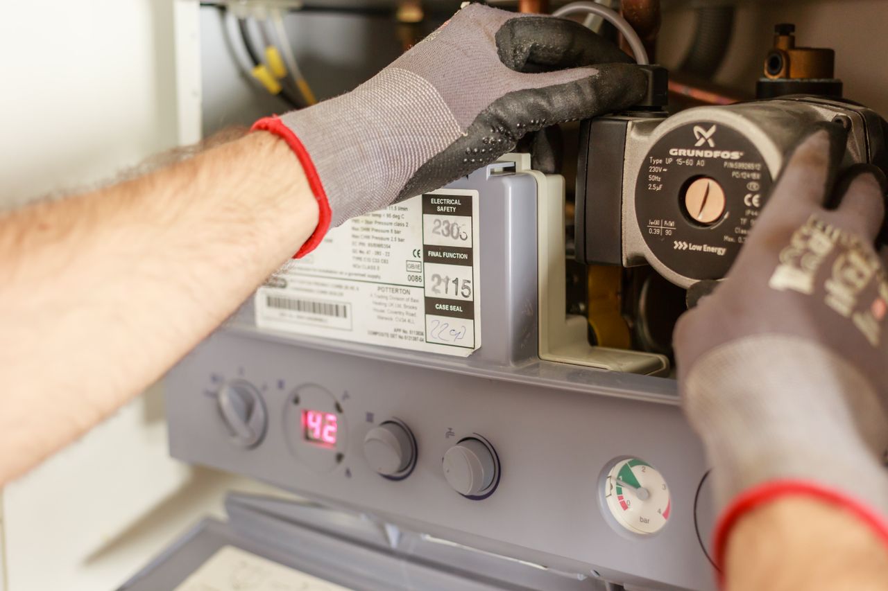 A technician servicing a boiler