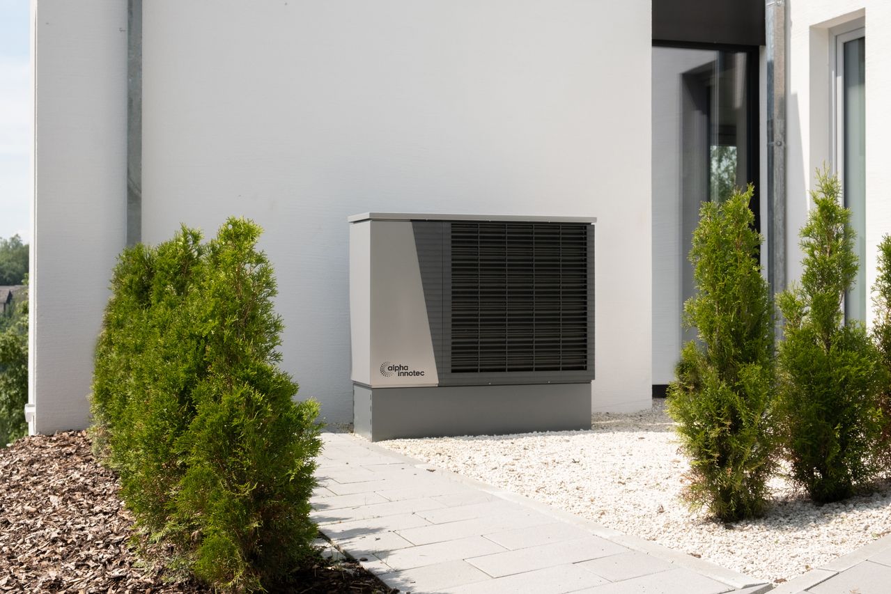 A modern heat pump unit installed outside a home